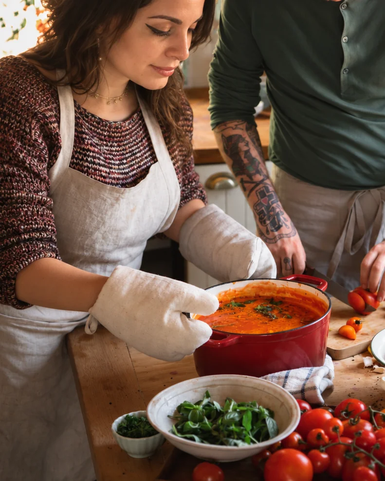 Preparing a pot of soup together in a warm home kitchen